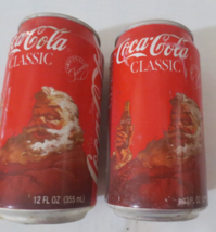 Two Coca-Cola Classic Santa Cans Tabs are on but empty Rust holes, marks... - $0.99