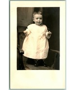 RPPC Adorable Smiling Baby Standing On Chair Wearing White AZO Postcard H5 - £3.23 GBP