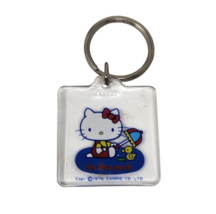 Vintage 1976 Sanrio Hello Kitty W/ Umbrella In The Park Clear Plastic Key Chain - £26.27 GBP