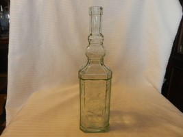 Vintage Clear Glass Bottle With Embossed Designs 11.75&quot; Tall - $35.63