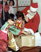 US Army soldier dressed as Santa Claus gives gifts to Korean kids Photo Print - $8.81+