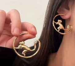 Monkey gold hoop earrings - $14.36