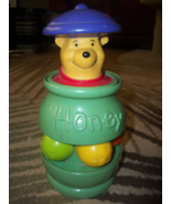 vintage winnie the pooh toy push down and it pops up after a spin. - $20.58 CAD
