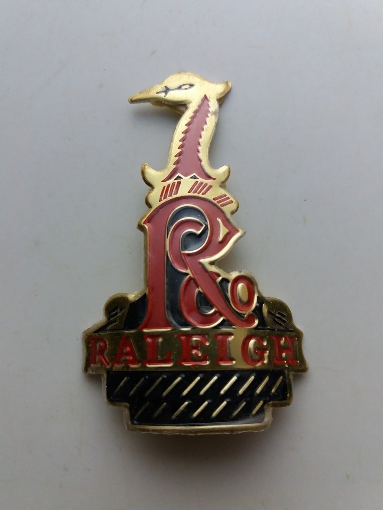 Raleigh emblem head badge thick aluminum red black gold color nos 1990's - $30.00