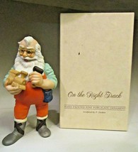 Hallmark Keepsake Ornament 1986 On The Right Track - Santa holding toy train - $11.18