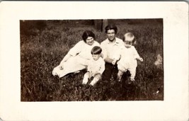 RPPC Sweet Family Sitting on Lawn Two Darling Children Postcard E22 - £6.25 GBP