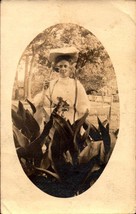 VINTAGE REAL PHOTO POSTCARD-WOMAN STANDING BEHIND LARGE PLANTS &amp; FLOWERS... - £3.87 GBP