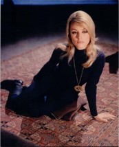 Sharon Tate in purple dress and boots sits on rug 8x10 inch photo - $12.00
