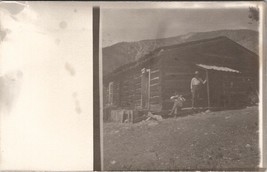 RPPC Early Log Cabin Construction Foot of Mountain Man with Rifle Postcard W9 - £10.35 GBP