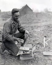 US soldier of Ninth Army opens Christmas package in Germany 1944 Photo Print - $8.81+
