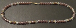 Beaded necklace; clear and brown; gold spacers; 22 inches long - $23.00