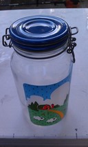 An item in the Collectibles category: 8FF79 KITCHEN STORAGE JAR WITH LID, GLASS, NINA 1982 FARM SCENE, 9-1/2" TALL +/-