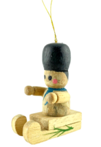 German Christmas Ornament Boy On A Wooden Sled Handmade Hand Painted - $9.74