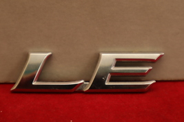 2007-2011 Toyota Camry “LE” Chrome Plastic Trunk Lid Emblem OEM - $10.34