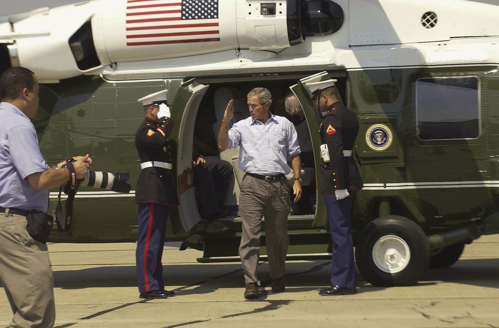 Primary image for President George W. Bush salutes as he exits Marine One at Keesler Photo Print