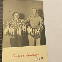 B&amp;W RPPC Man And Woman With Lots Of Fish Smiling Seasons Greeting Christ... - $9.00