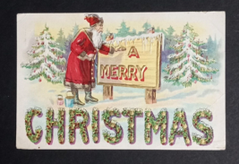 Santa Painting A Merry Christmas Large Letter Sign Gold Embossed Postcard c1910s - £6.40 GBP