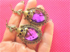 Purple cameo skull earrings - $190.40 MXN