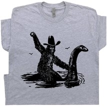 Bigfoot T Shirt Riding Loch Ness Monster Shirts Cool Sasquatch Rodeo Graphic Tee - £15.72 GBP