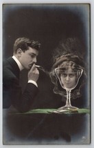 RPPC Fantasy Trick Photography Man Smoke Cigarette Woman Face Glass Post... - $29.95