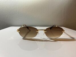 Unisex, rimless, oval shaped sunglasses with brown lenses and gold frame - $8.00