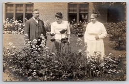 RPPC Lovely Older Women Gentleman Admiring the Beautiful Flowers Postcard G26 - £9.74 GBP