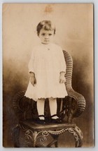 Adorable Little Girl Big Brown Eyes White Dress Wicker Chair Postcard E23 - £7.79 GBP