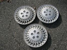 Genuine 1985 to 1989 Pontiac Grand AM 13 inch hubcaps wheel covers white - $27.70