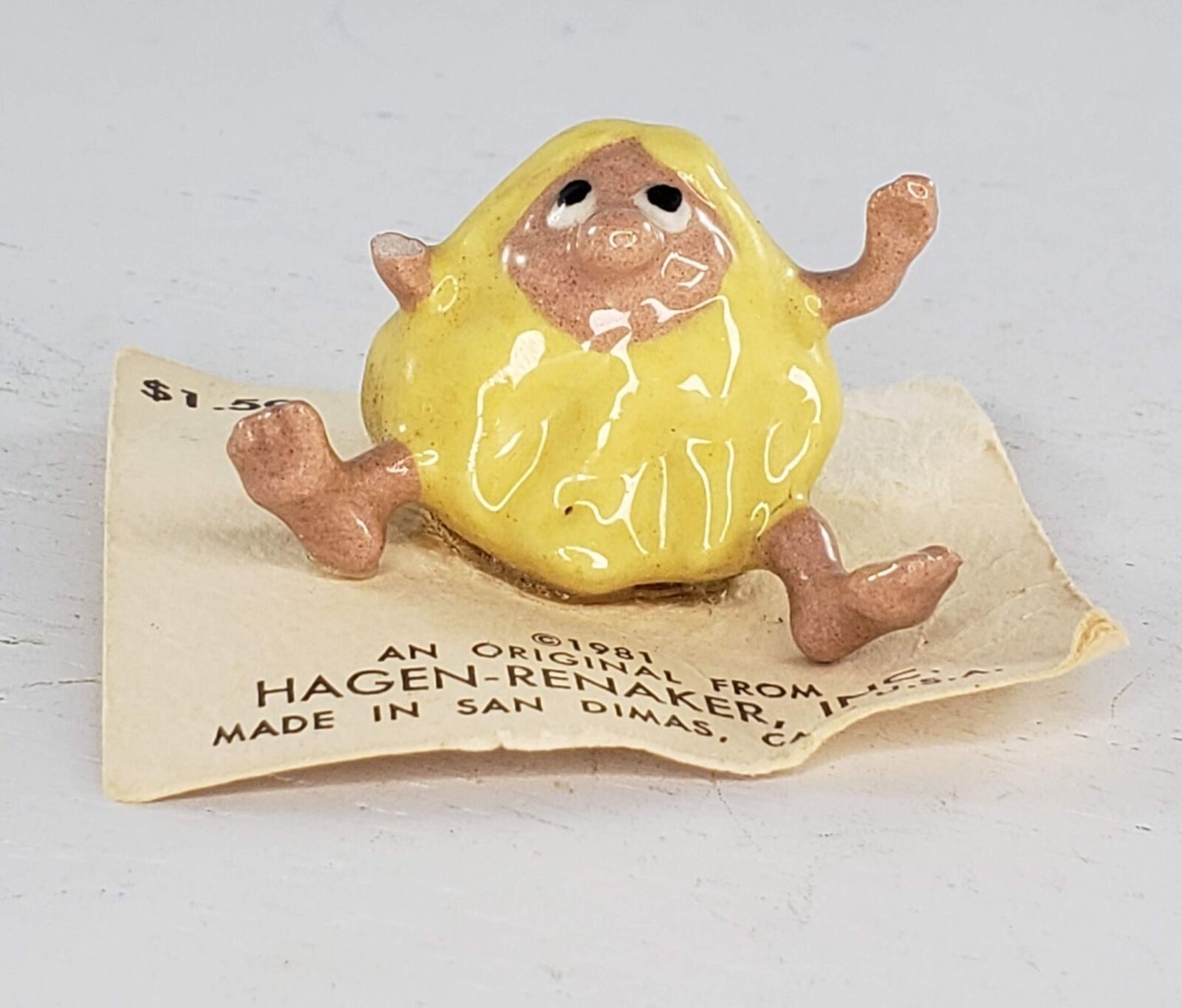 Hagen Renaker Beach Boy Yellow Caveman Sitting Miniature Figurine *Missing Arm* - $22.27