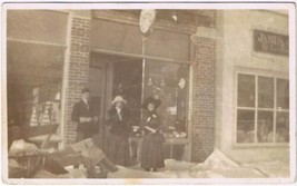 Postcard RPPC Christmas Photo Two Ladies &amp; Gentleman Outside Shop - $4.94