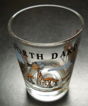North Dakota Shot Glass Clear Glass with Brown Blue Illustrations Black Print - £5.58 GBP