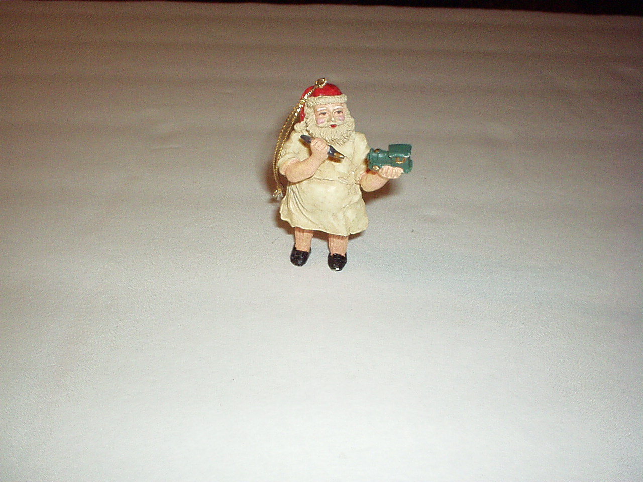 Primary image for Antique Ceramic SANTA Figurine in work Apron Repairing Train Toy w/Gold Hanger