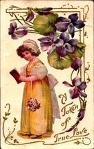 HEAVILY EMBOSSED POSTCARD-A TOKEN OF TRUE LOVE-GIRL WITH BOOK &amp; FLOWERS ... - $6.93