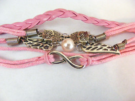 ONE DIRECTION BRIGHT PINK BRAIDED AND CORDED BRACELET TWO OWLS AND WINGS - $5.34