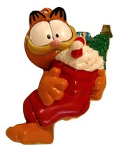 Garfield holding red fireplace sock with gifts in it  Christmas Ornament - $11.65