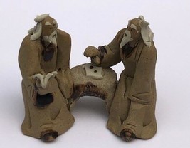 Ceramic Figurine Two Mud Men Sitting On A Bench Reading Book 2&quot; - £6.21 GBP