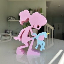 A girl at play with her toy unicorn, holding onto the magic of childhood - $29.00