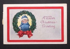 A Warm Christmas Greeting Wreath Bow Kid w/ Blue Muff Embossed Postcard c1920s - £5.51 GBP