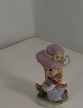 4 inch ceramic figure of girl with pink hat lacing up boots good - £4.64 GBP