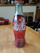 Coca Cola wrapped Holiday 2004 Santa bottle.  Empty.  recapped - $2.96