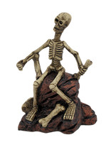 Zeckos Creepy Skeleton Sitting On Rocks Statue Figure - $14.46
