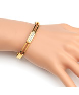 Gold Tone Bangle Bracelet With Sparkling Crystal Bar - $513.83 MXN