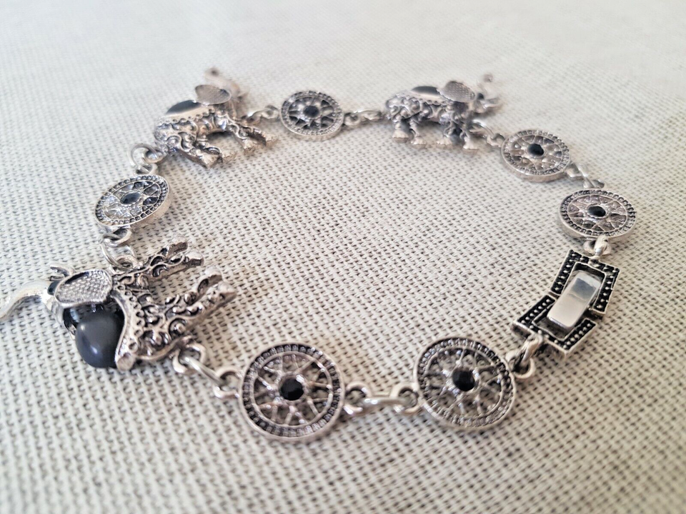 Vintage trumpeting silver elephant bracelet with black stones. - $17.73