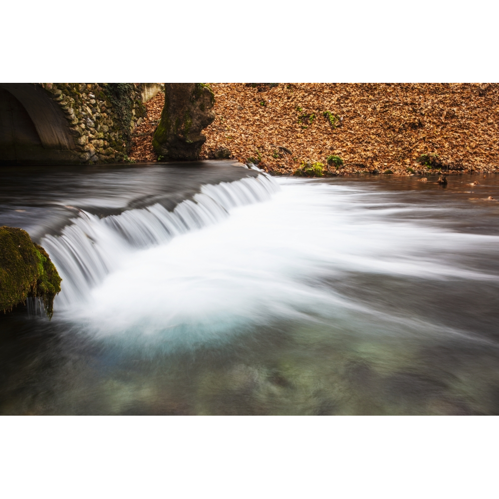Water Cascading Over A Ledge in a River with The Riverbank Covered with ... - $114.64