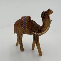 hand carved wooden camel. Red saddle. Chain hanging from neck. - $11.30