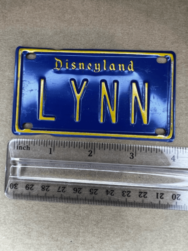 Primary image for DISNEYLAND Vintage LYNN Mini License Plate-Blue/Yellow Embossed Metal 2”x4”