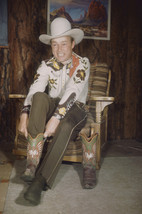 Roy Rogers slipping on cowboy boots brown pants hat 18x24 Poster - £19.17 GBP
