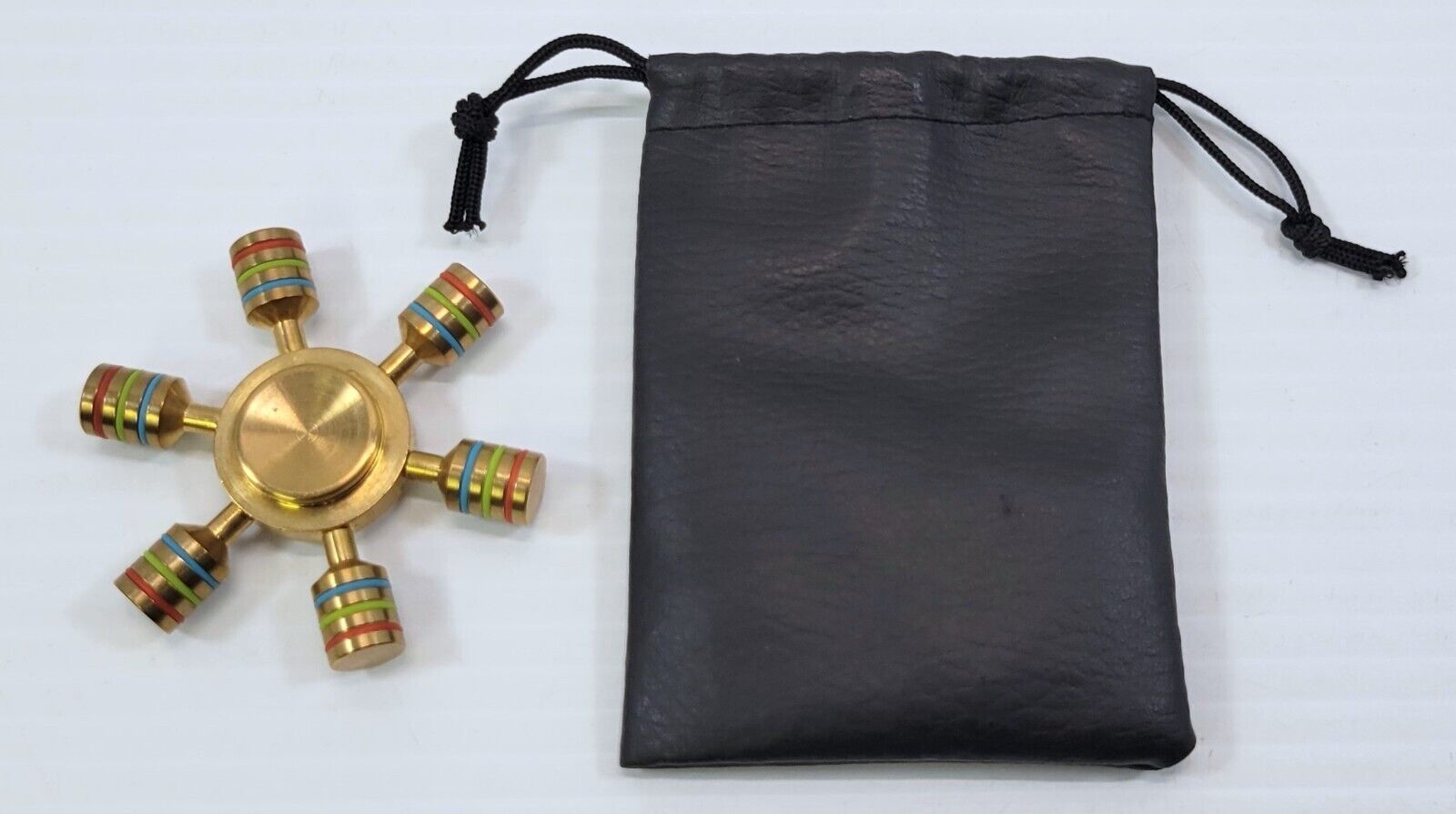 *B2) Brass Metal Ship Wheel Colorful Cylinder Peg Hand Fidget Spinner Toy - $14.84