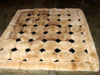 Light brown alpaca fur carpet with black rhombus designs, 90 x 60 cm - $184.50