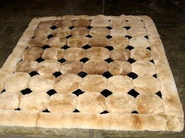 Light brown alpaca fur carpet with black rhombus designs, 90 x 60 cm - $184.50